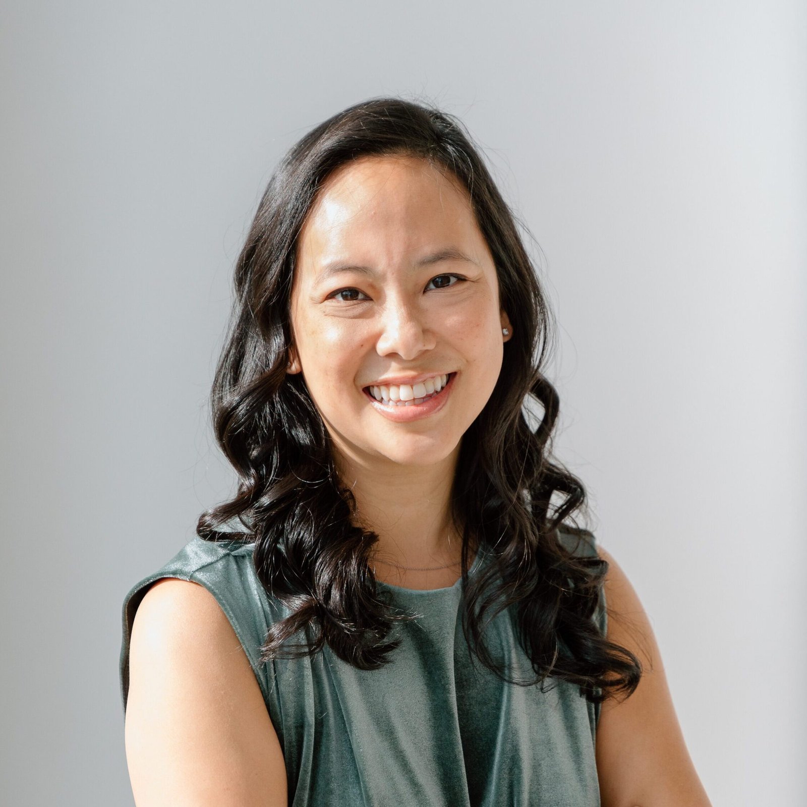 Profile headshot of Dr. Vivian Rostova, Biohacking Consultant, smiling and wearing a teal-green velvet top.