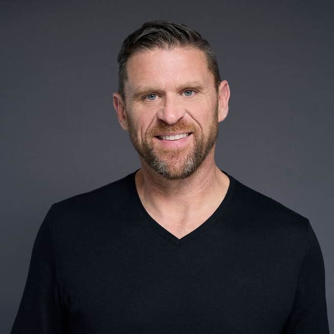 Profile headshot of Dr. Matt Carter, Biochemistry Researcher, smiling and wearing a black v-neck t-shirt.